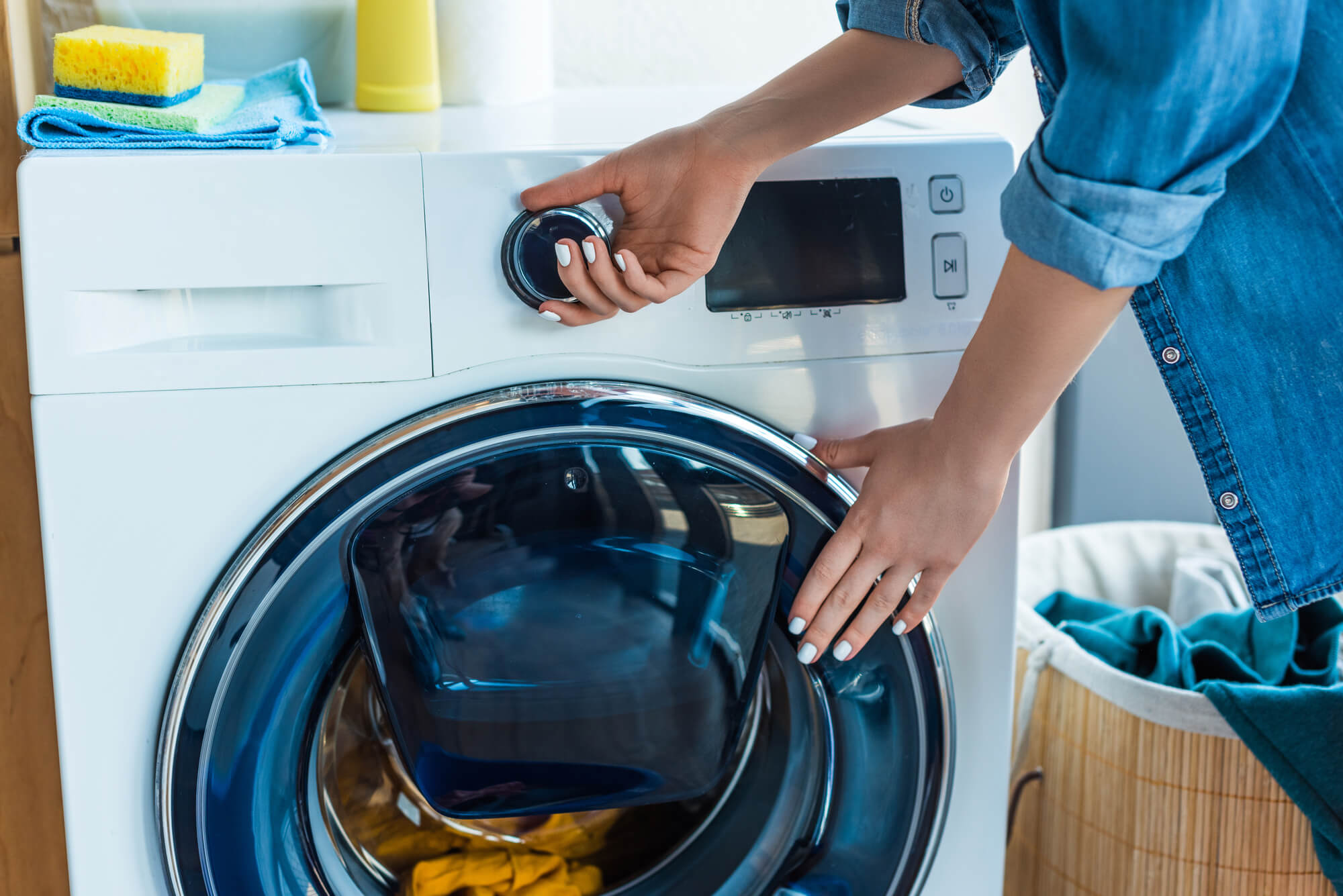 woman putting clothes into a washing machine