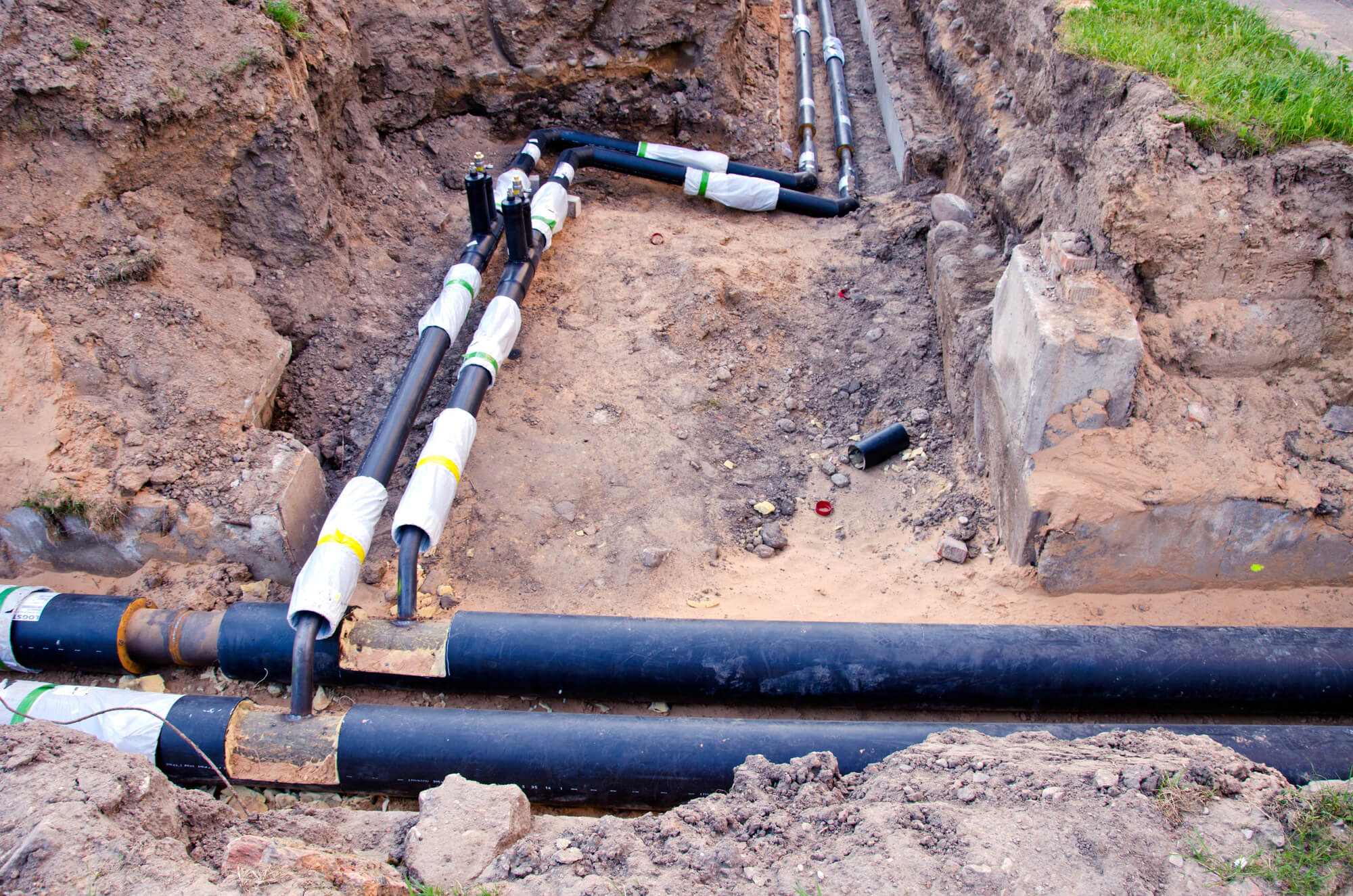 Traditional pipe repair in backyard excavation