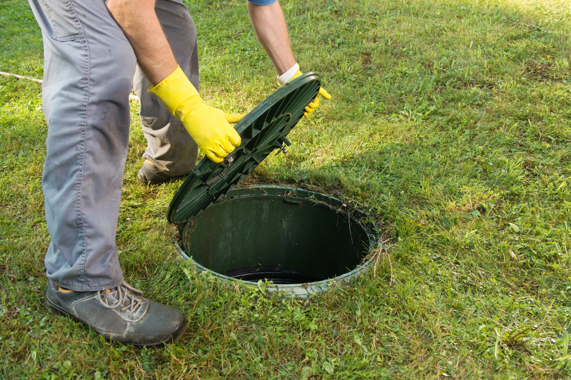 Opening septic tank lid. Cleaning and unblocking septic systems