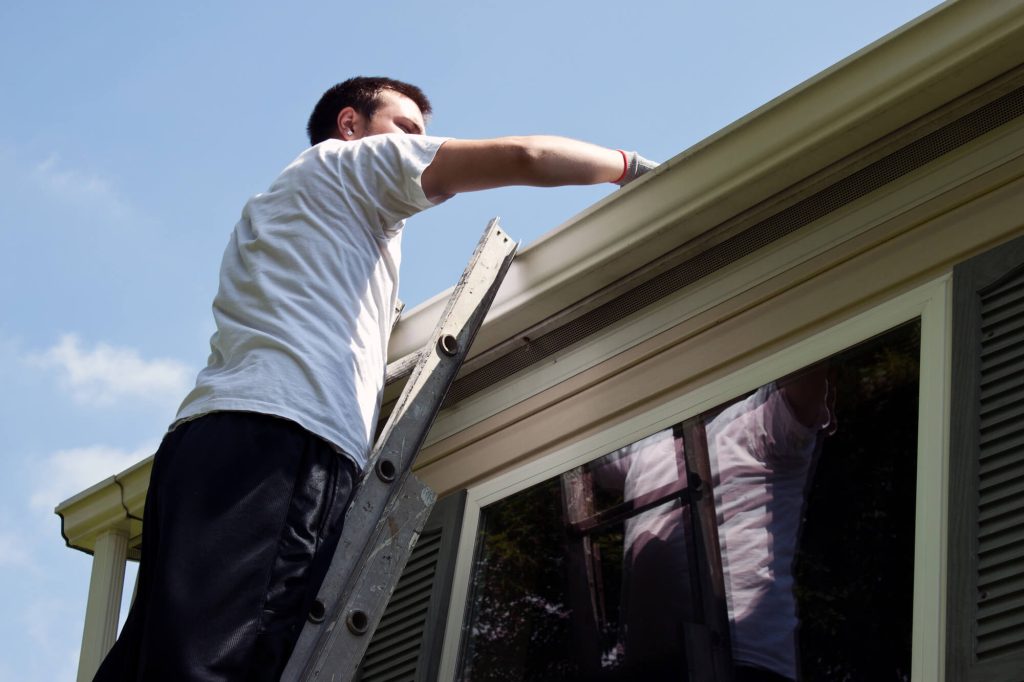 Man cleaning the gutter