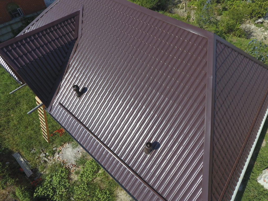 The roof of corrugated sheet. Roofing of metal profile wavy shape.