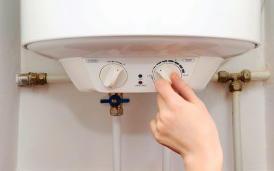 Hands young women set the temperature of the water in the electric water broiler