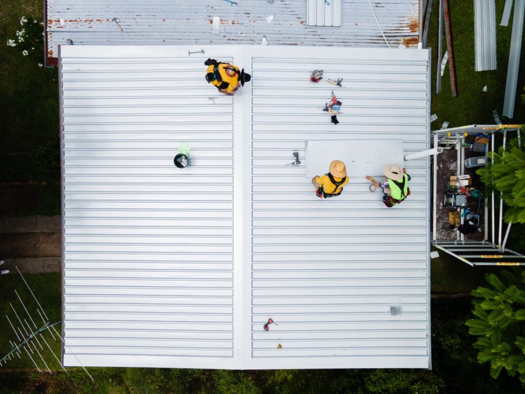 Brisbane plumbing & drainage Workers installing roof tiles for home building