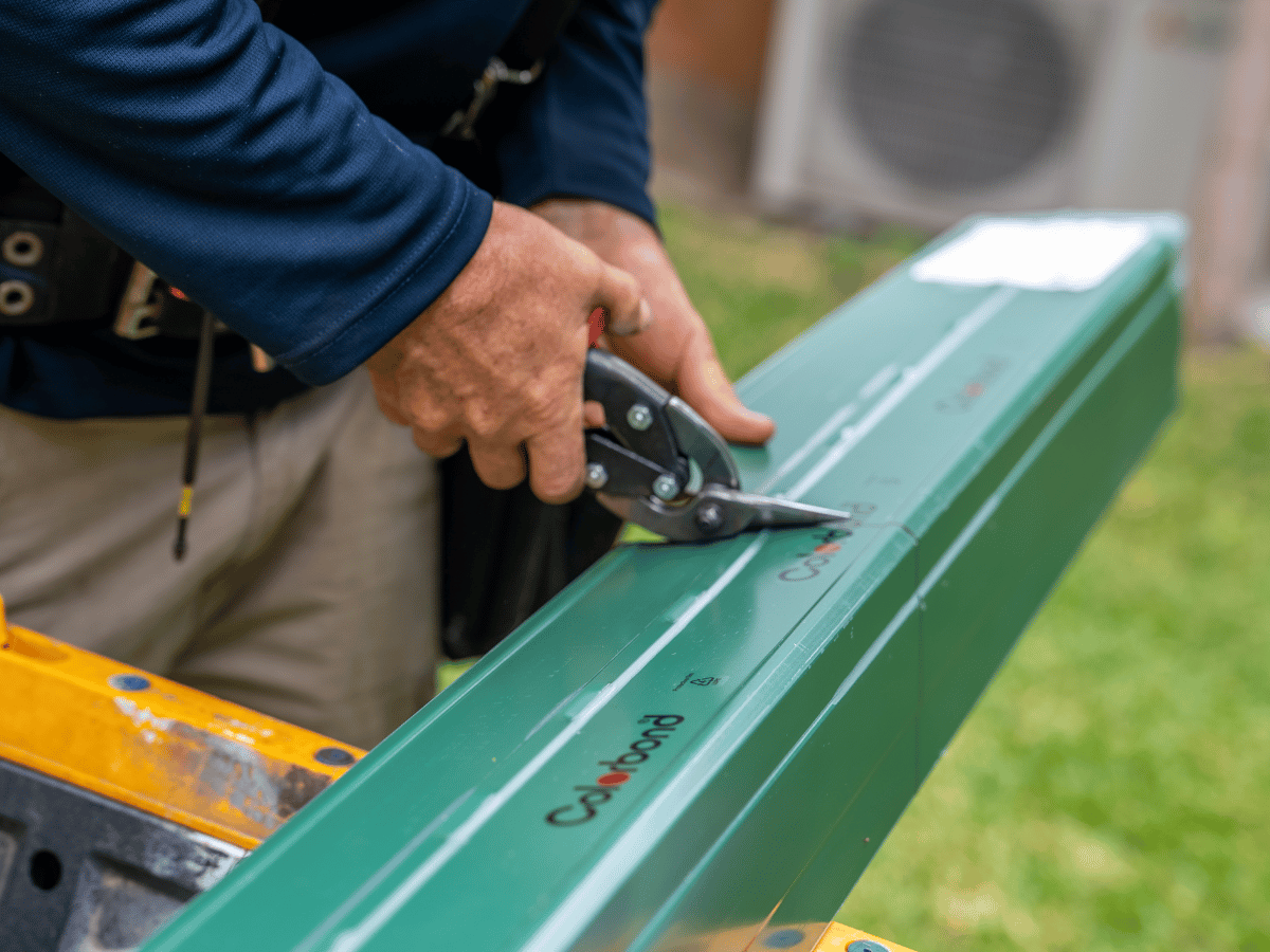 Roof repair specialists installing new gutter system for leaking roof repairs Brisbane home.