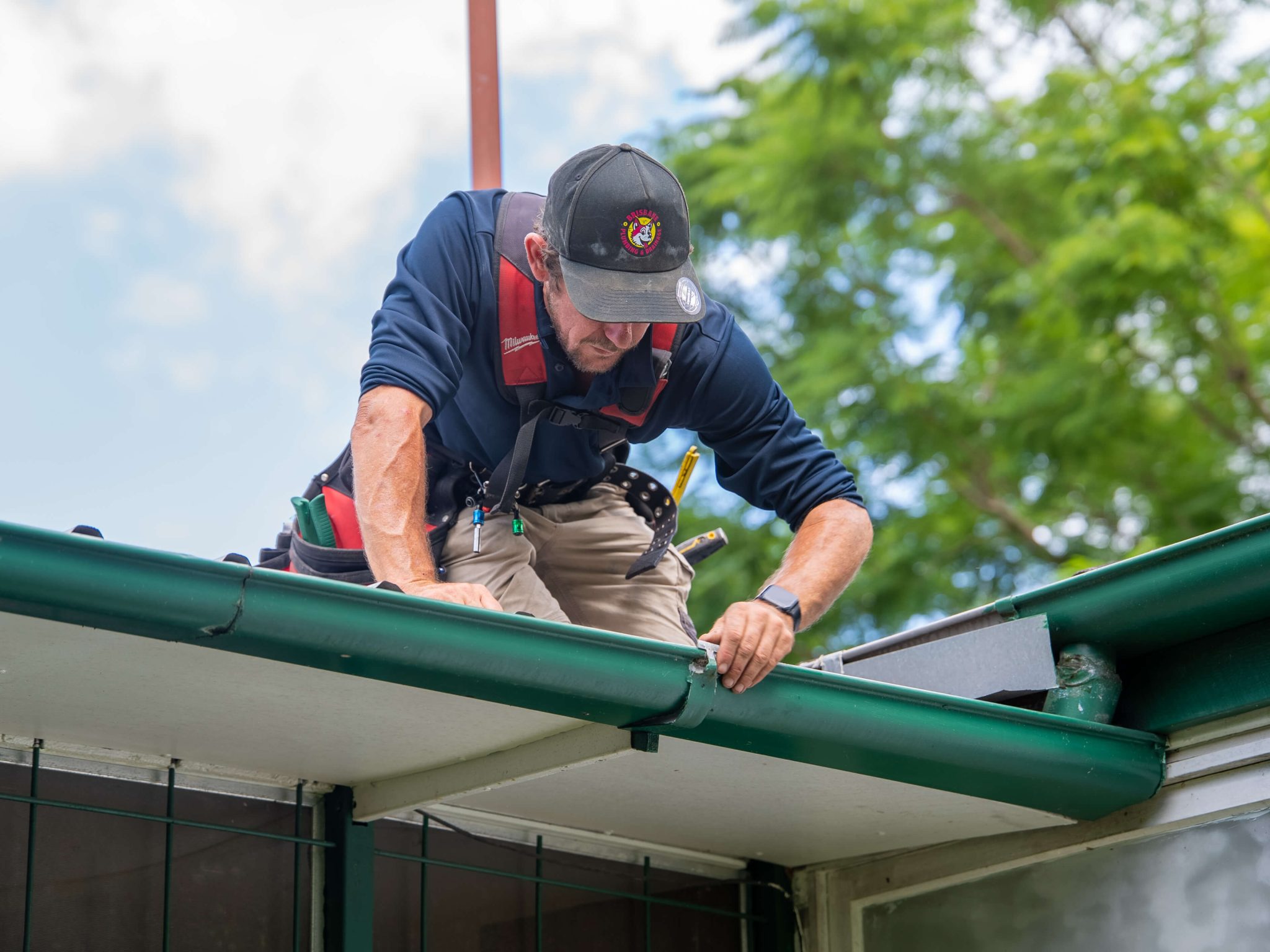 Plumber Brisbane repairing damaged roof gutter to prevent leaks and water damage.